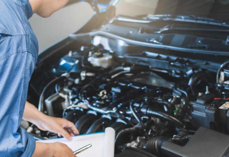 Asian,Man,Mechanic,Inspection,Writing,Note,On,Clipboard.blue,Car,For