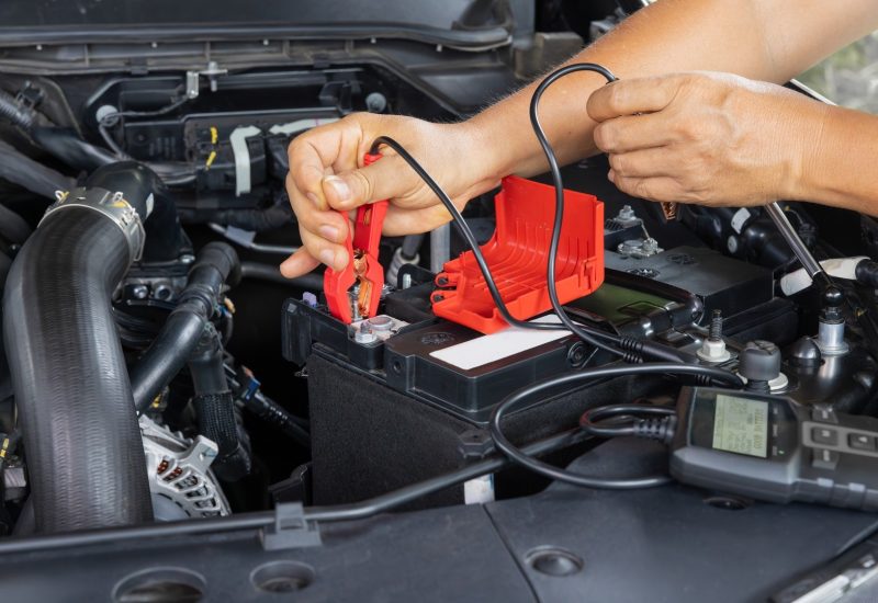 Man,Is,Measuring,Agm,Battery,Power,Of,Suv,Car,By